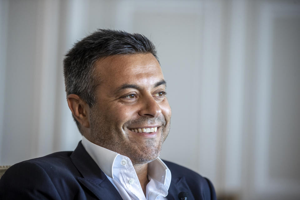 In this photo taken on Wednesday, Aug. 19, 2020, Leeds owner Andrea Radrizzani smiles during an interview with the Associated Press in Lisbon, Portugal. Leeds is counting on Marcelo Bielsa leading the team in the Premier League while planning for a future without the enigmatic manager. In his second season in charge, the Argentine ended the team’s 16-year exile from the world’s richest league by gaining promotion as Championship winners before his contract expired last month. (AP Photo/Manu Fernandez)