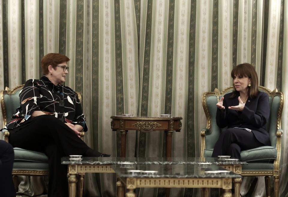 Greece's President Katerina Sakellaropoulou, right, speaks with the Australian Foreign Minister Marise Payne after their meeting at the Presidential Palace in Athens, Greece, Wednesday, Dec. 8, 2021. The foreign minister of Australia, launching a European tour in Athens Wednesday, welcomed a recent initiative by the European Union to boost its presence in the Indo-Pacific region despite a spat with EU member France over the cancelation of a massive submarine order. (John Liakos/InTime News via AP)