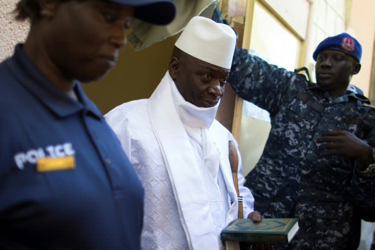 Gambia's President Yahya Jammeh (centre) leaves a polling booth in Banjul on December 1, 2016