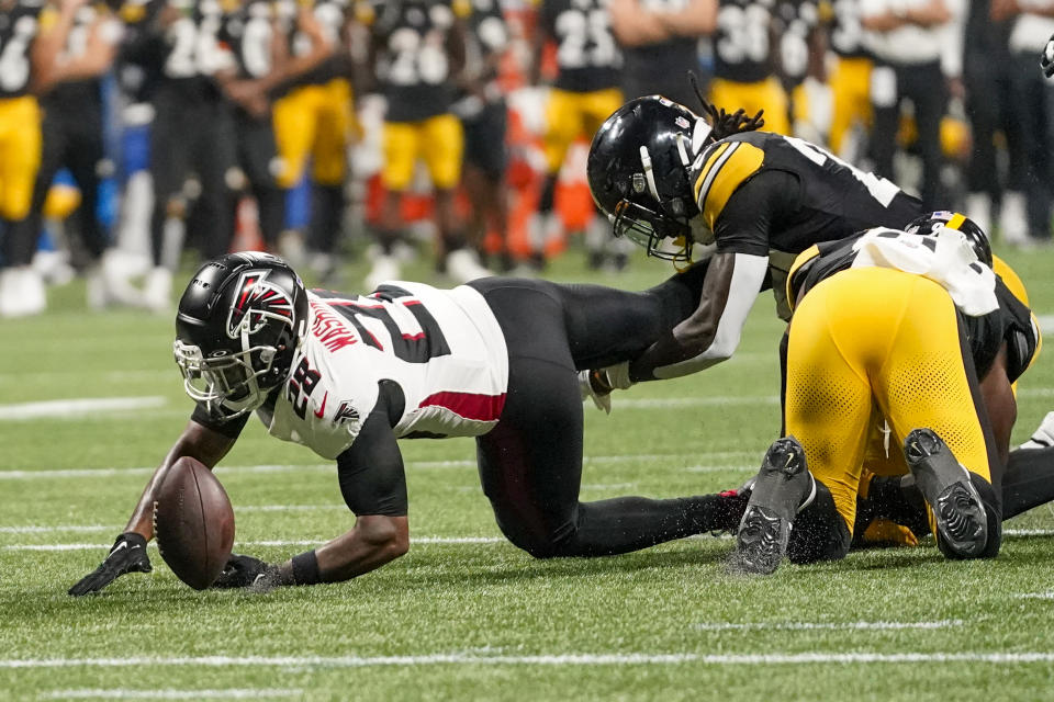 Atlanta Falcons running back Carlos Washington Jr. fumbles against the Pittsburgh Steelers during the second half of a preseason NFL football game Thursday, Aug. 24, 2023, in Atlanta. (AP Photo/Gerald Herbert)