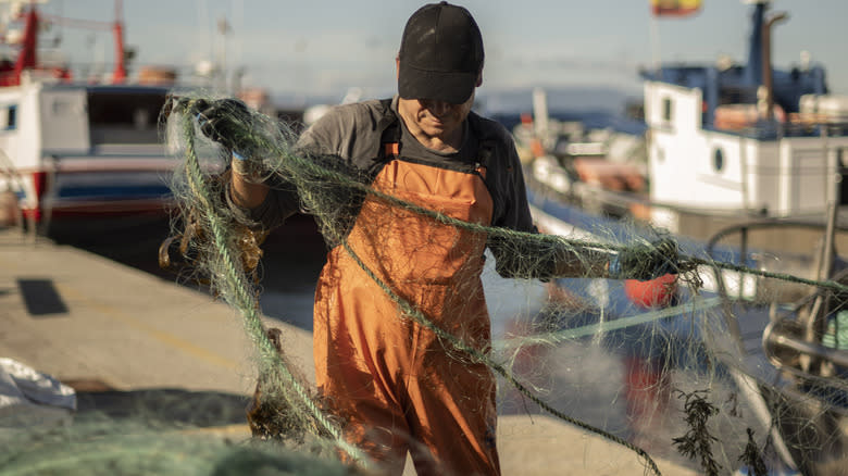fisherman adjusting nets