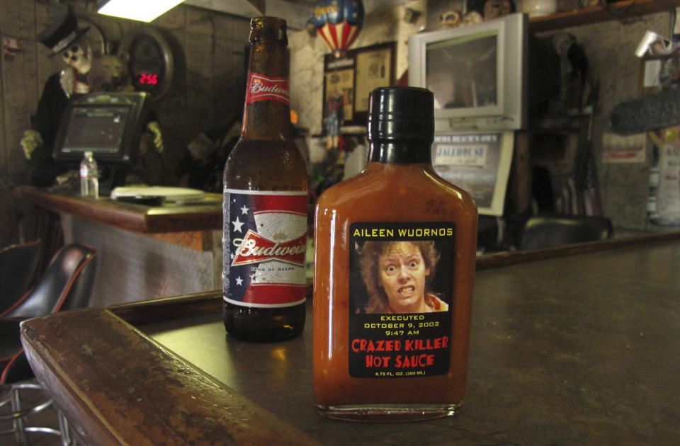 In this May 3, 2012 photo, an image of serial killer Aileen Wuronos is seen on the side of a hot sauce bottle at The Last Resort bar in Port Orange, Fla. Almost 22 years after Wuornos was arrested at The Last Resort, the curious still come to the place where she had her last drink. And at the Scoot Inn down the street, it's not unusual for people to walk into the motel office and ask to stay in the same room Wuornos did when she committed a string of murders that left seven men dead. (AP Photo/Brendan Farrington)