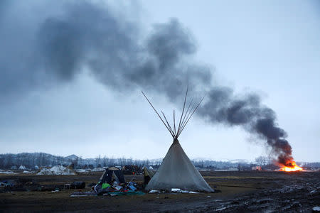 A building burns after being set alight by protesters preparing to evacuate the main opposition camp against the Dakota Access oil pipeline near Cannon Ball, North Dakota, U.S., February 22, 2017. REUTERS/Terray Sylvester