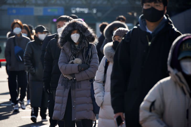 People wait in a line to undergo coronavirus disease (COVID-19) test at a coronavirus testing site in Seoul