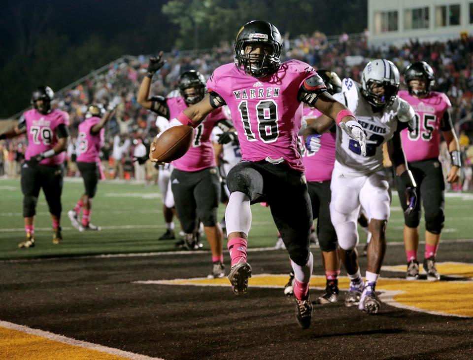 Warren Central's Mykelti Williams celebrates his touchdown to put them up 28-21 over Ben Davis at Warren Central High School on September 19, 2014. Warren held on to win 28-21.