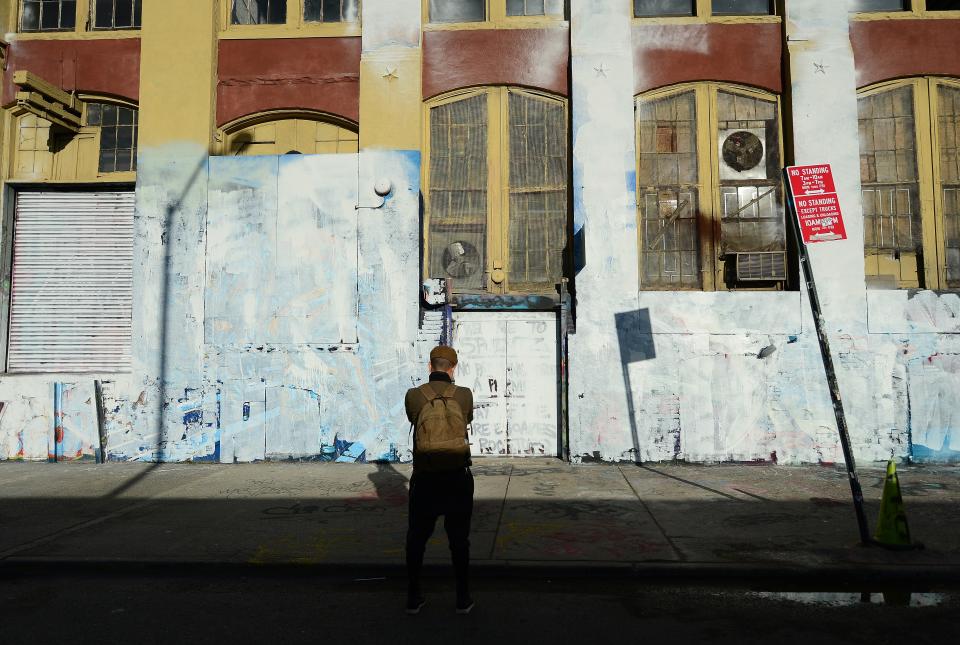 A visitor takes in the whitewashed walls that once displayed some of the world's best graffiti art.