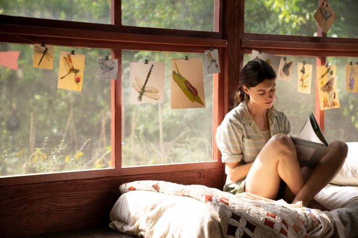 Kya Clark sits on her bed in Where the Crawdads Sing.