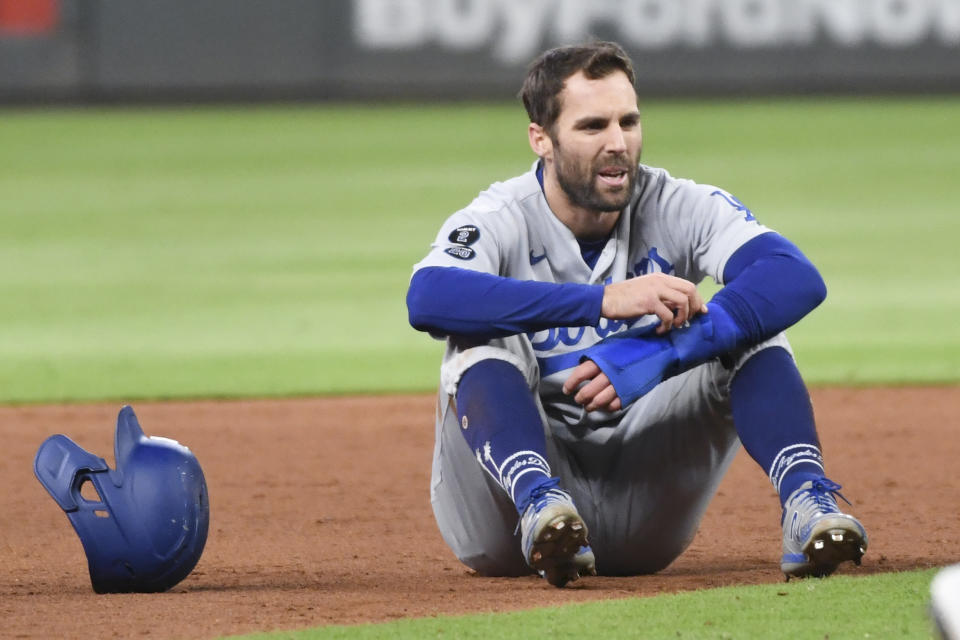 Atlanta, GA - October 16: Los Angeles Dodgers' Chris Taylor sits on the field after being caught in a rundown and tagged out by Atlanta Braves shortstop Dansby Swanson during the ninth inning in game one in the 2021 National League Championship Series at Truist Park on Saturday, Oct. 16, 2021 in Atlanta, GA.(Wally Skalij / Los Angeles Times via Getty Images)