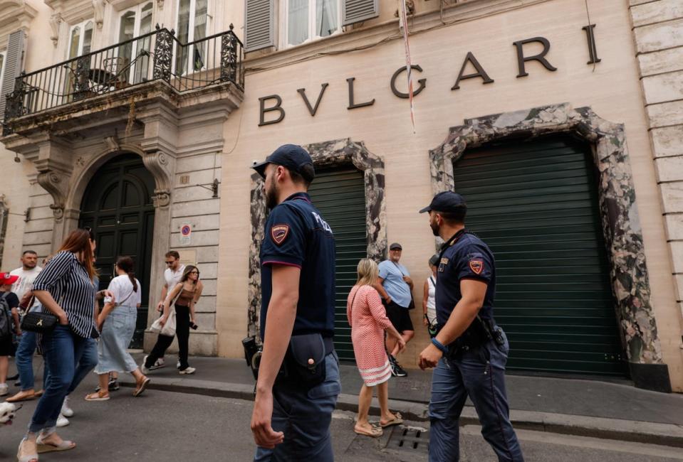 Police officers stand outside the Bulgari store in via Condotti, Rome (EPA)