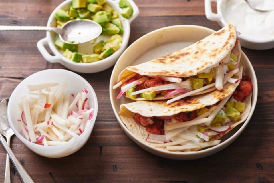 <p>Katie Workman</p><p>These fun change-of-pace tacos feature plump bites of shrimp in a tangy, saucy tomato mixture. Warm up some tortillas and let the whole family top as they wish!</p><p><strong>Get the recipe: <a href="https://themom100.com/recipe/shrimp-tacos/" rel="nofollow noopener" target="_blank" data-ylk="slk:Shrimp Tacos;elm:context_link;itc:0;sec:content-canvas" class="link ">Shrimp Tacos</a></strong></p>