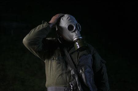 65 year-old Hans-Georg Tiede wears a gas mask during the 'reality event' one night at the 'Bunker-Museum' in Rennsteighoehe near the eastern city of Ilmenau October 12, 2013. REUTERS/Ina Fassbender