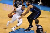 Apr 16, 2016; Oklahoma City, OK, USA; Oklahoma City Thunder guard Russell Westbrook (0) drives to the basket defended by Dallas Mavericks center JaVale McGee (11) during the second quarter of game one of their first round NBA Playoffs series at Chesapeake Energy Arena. Mandatory Credit: Mark D. Smith-USA TODAY Sports