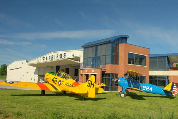 The Tri-State Warbird Museum planes rest on the lawn of the Clermont County Airport.