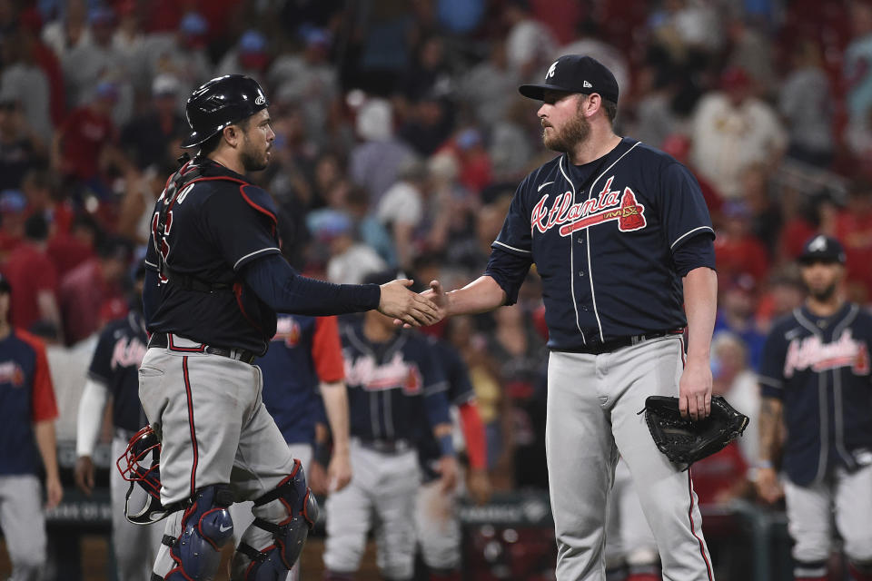 Atlanta Braves relief pitcher Tyler Matzek (68), right, and teammate Travis d'Arnaud (16) celebrate their teams 11-4 victory over the St. Louis Cardinals in a baseball game on Friday, Aug. 26, 2022, in St. Louis. (AP Photo/Joe Puetz)