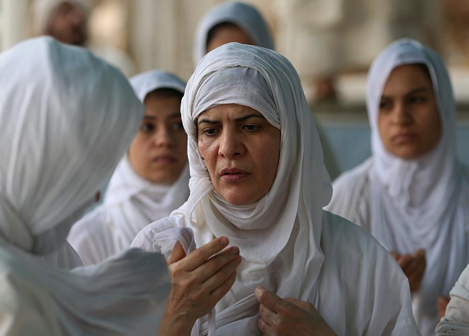 In this Sunday, Oct. 14, 2018 photo, followers of the obscure and ancient Mandaean faith performs rituals along a strip of embankment on the Tigris River reserved for them, in Baghdad, Iraq. Iraq’s soaring water pollution is threatening the religious rites of its tight-knit Mandaean community, already devastated by 15 years of war that has also affected the country’s other minority Abrahamic sects. (AP Photo/Hadi Mizban)