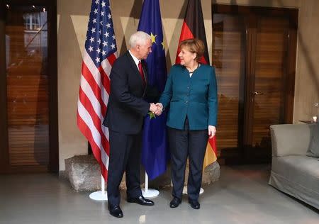 German Chancellor Angela Merkel poses for a picture with U.S. Vice President Mike Pence before their meeting at the 53rd Munich Security Conference in Munich, Germany, February 18, 2017. REUTERS/Michael Dalder