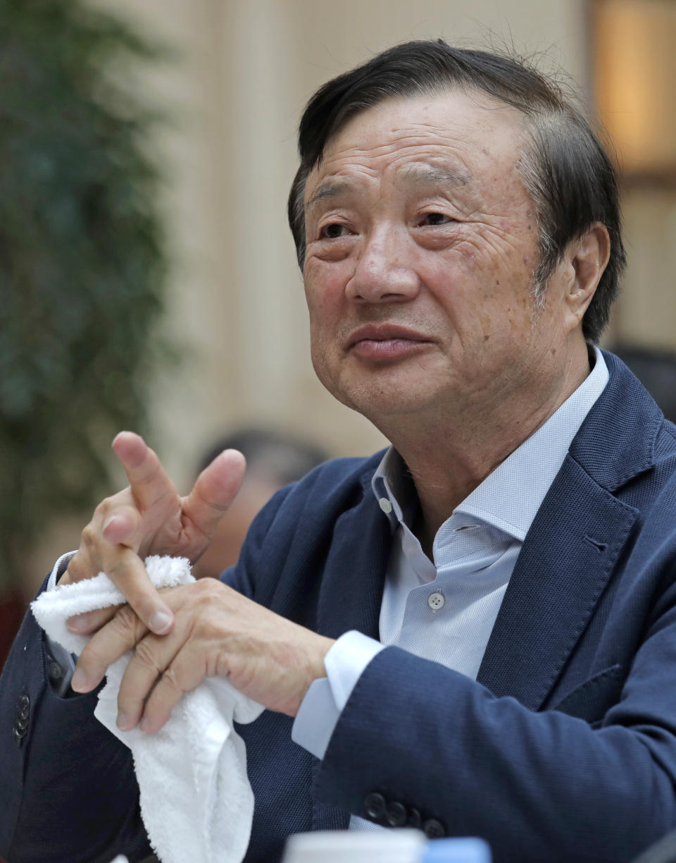 Ren Zhengfei, founder and CEO of Huawei, wipes his fingers with a towel during a round table meeting with the media in Shenzhen city, south China's Guangdong province, Tuesday, Jan. 15, 2019. The founder of network gear and smart phone supplier Huawei Technologies said the tech giant would reject requests from the Chinese government to disclose confidential information about its customers. (AP Photo/Vincent Yu)