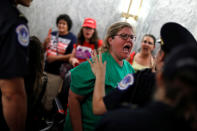 <p>Capitol Police detain a demonstrator as the Senate Finance Committee holds a hearing on the latest Republican Effort to repeal and replace the Affordable Care Act on Capitol Hill in Washington, U.S. September 25, 2017. (Photo: Aaron P. Bernstein/Reuters) </p>