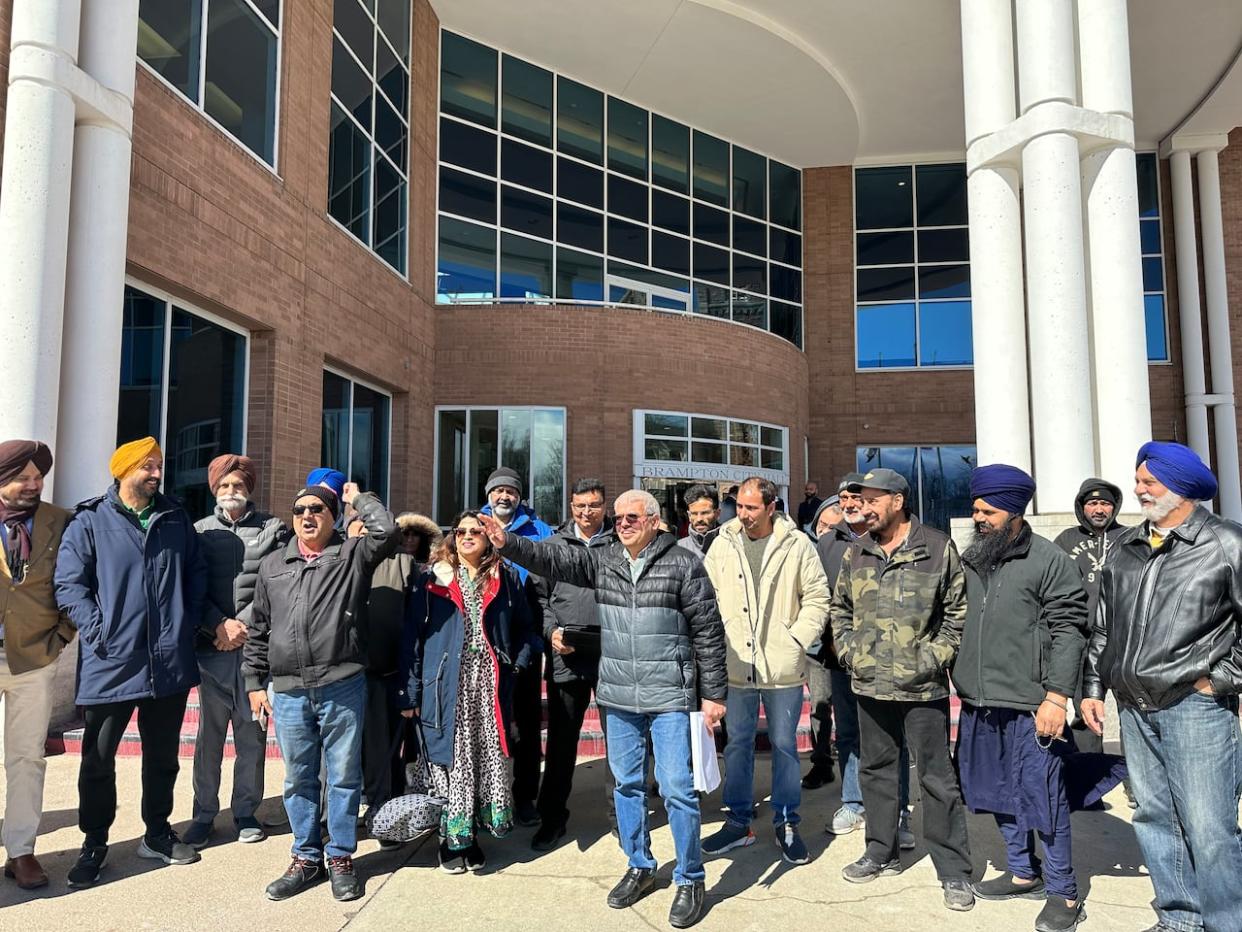 Protesters shouted slogans of 'No to RRL' outside Brampton city hall after city staff announced to relaunch the contentious Residential Rental Licensing Pilot in five of the city's wards. (Saloni Bhugra/CBC - image credit)