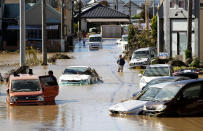 Vehicles are seen in mud water as Typhoon Hagibis hit the city in Sano, Tochigi prefecture, Sunday, Oct. 13, 2019. Rescue efforts for people stranded in flooded areas are in full force after a powerful typhoon dashed heavy rainfall and winds through a widespread area of Japan, including Tokyo.(Kyodo News via AP)