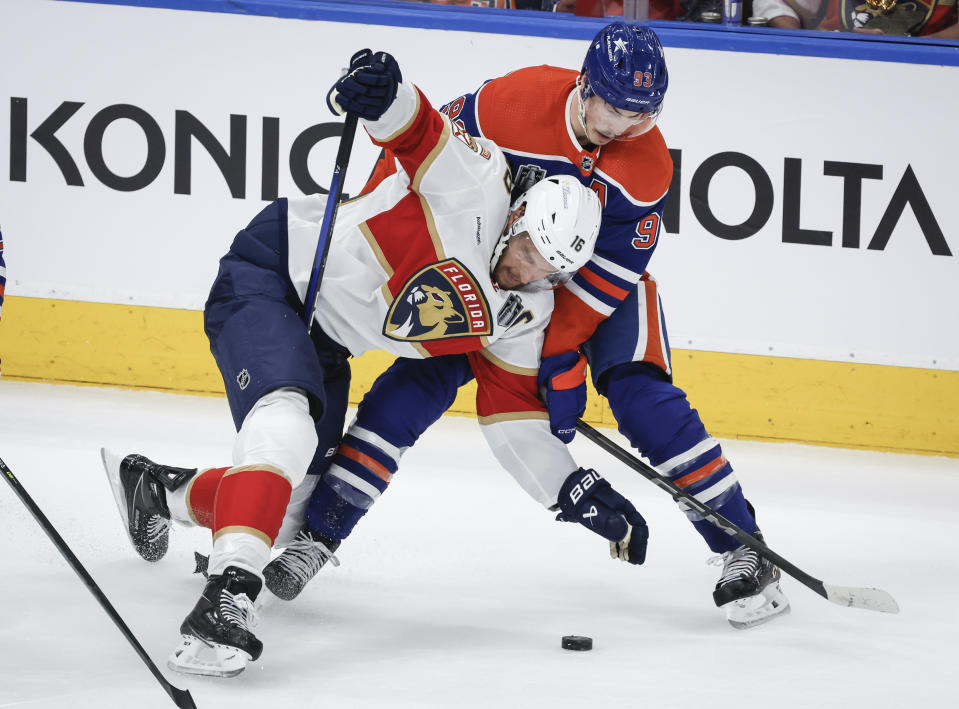 Florida Panthers' Aleksander Barkov (16) is checked by Edmonton Oilers' Ryan Nugent-Hopkins (93) during the first period of Game 4 of the NHL hockey Stanley Cup Final, Saturday, June 15, 2024, in Edmonton, Alberta. (Jeff McIntosh/The Canadian Press via AP)