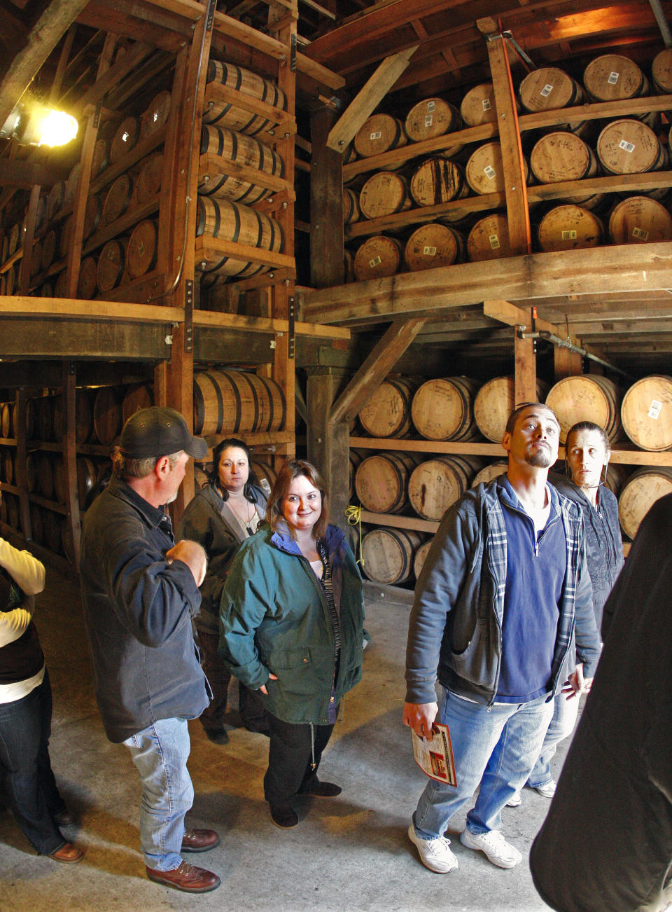 FILE -- This Nov. 27, 2009 file photo shows visitors viewing barrels of aging whiskey while on a tour of the Jack Daniel's distillery in Lynchburg, Tenn. The 70-mile trip from Nashville to Lynchburg offers a free tour of the oldest registered American distillery. (AP Photo/Mark Humphrey, File)