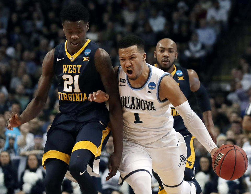 Villanova’s Jalen Brunson, right, tries to drive past West Virginia’s Wesley Harris, left, during the first half of an NCAA men’s college basketball tournament regional semifinal Friday, March 23, 2018, in Boston. (AP Photo/Charles Krupa)