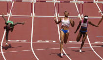 Jasmine Camacho-Quinn, of Puerto Rico, center, celebrates after winning the gold in the women's 100-meters hurdles final ahead of Kendra Harrison, of United States, silver, right, and Tobi Amusan, of Nigeria, fourth, at the 2020 Summer Olympics, Monday, Aug. 2, 2021, in Tokyo, Japan. (AP Photo/Charlie Riedel)