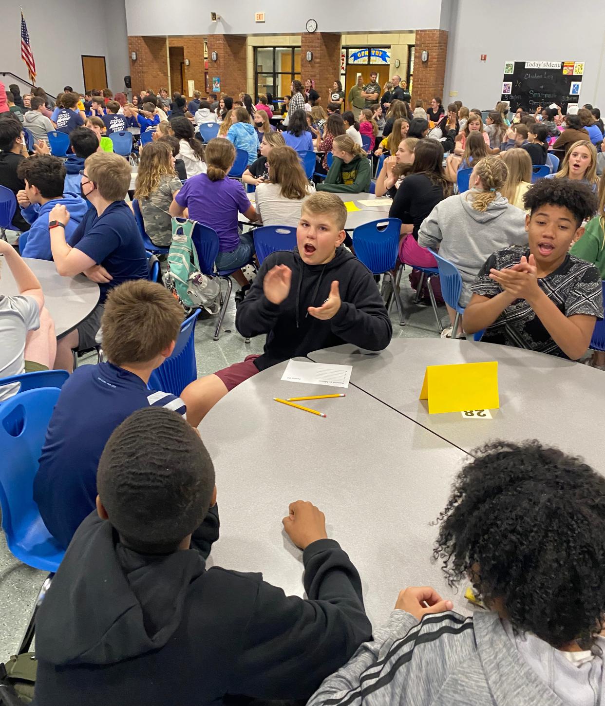 Gentry Middle School 7th graders Ryan McClain, left, and Coleon Goolsby cheer a correct answer in a trivia match on the last full day of school in CPS.