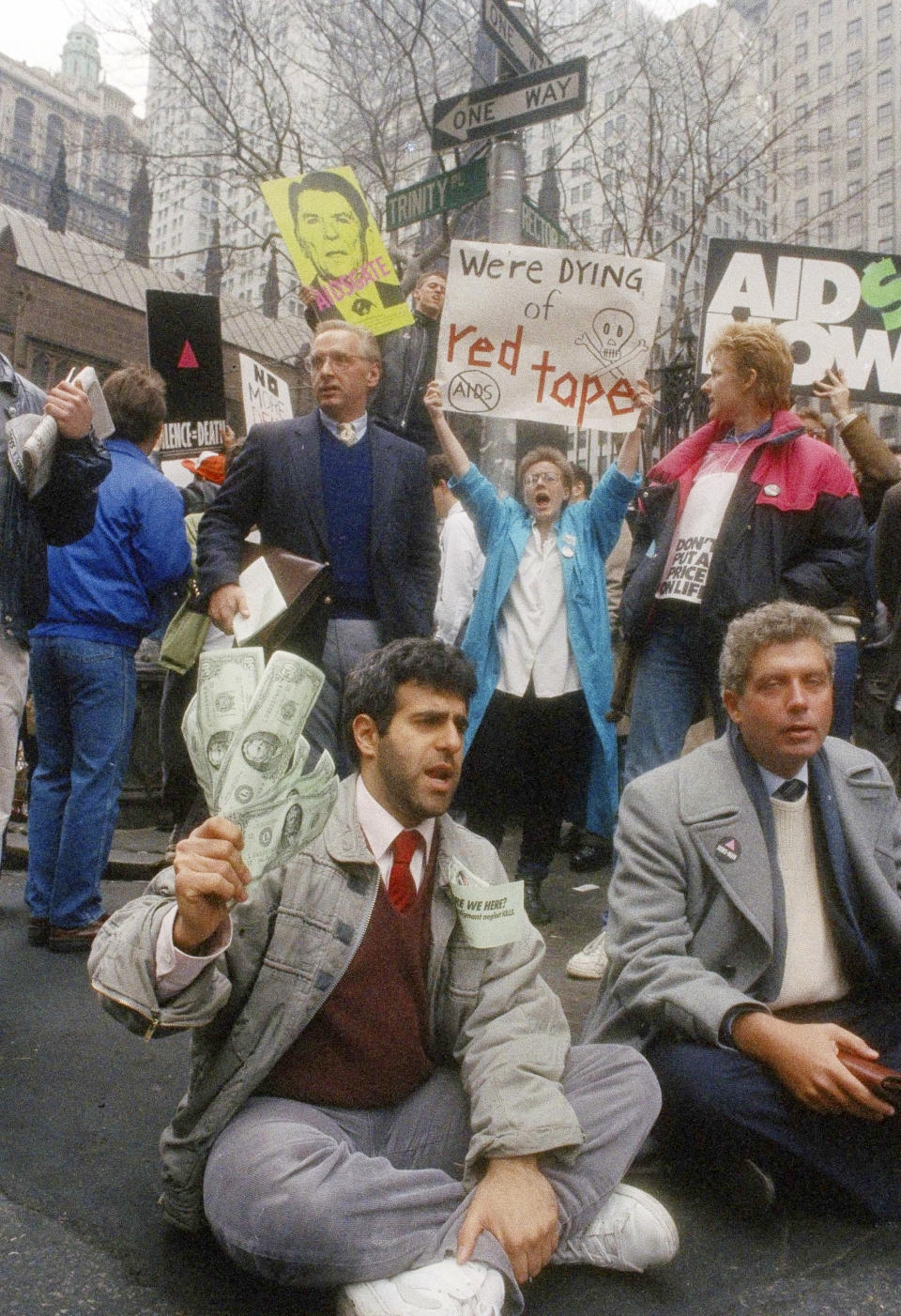 FILE - In this March 24, 1988 file photo, demonstrators stage a sit-in at the corner of Trinity and Rector Streets in New York protesting what they call a lack of government concern about AIDS. (AP Photo/Ed Bailey, File)