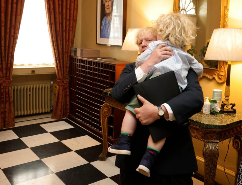 Boris Johnson hugs his son Wilfred as he arrives back into No10 after resigning as the leader of the Conservative Party (Andrew Parsons / No10 Downing Street)