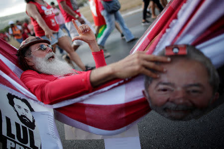 Supporters of imprisoned former Brazil's President Luis Inacio Lula da Silva attend a march before his Workers' Party (PT) officially registers his presidential candidacy, in Brasilia, Brazil, August 15, 2018. REUTERS/Ueslei Marcelino