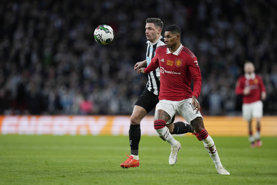 Newcastle's Paul Dummett, left, and Manchester United's Marcus Rashford challenge for the ball during the English League Cup final soccer match between Manchester United and Newcastle United at Wembley Stadium in London, Sunday, Feb. 26, 2023. (AP Photo/Alastair Grant)