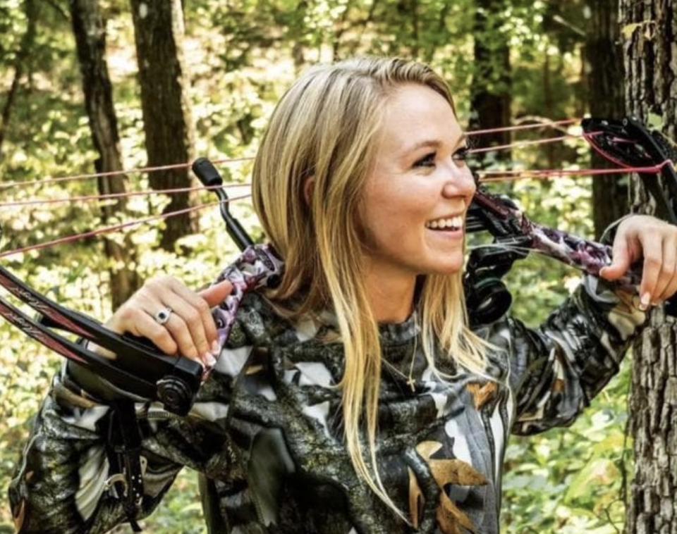 Brooke McGee, 26, holding a hunting bow.