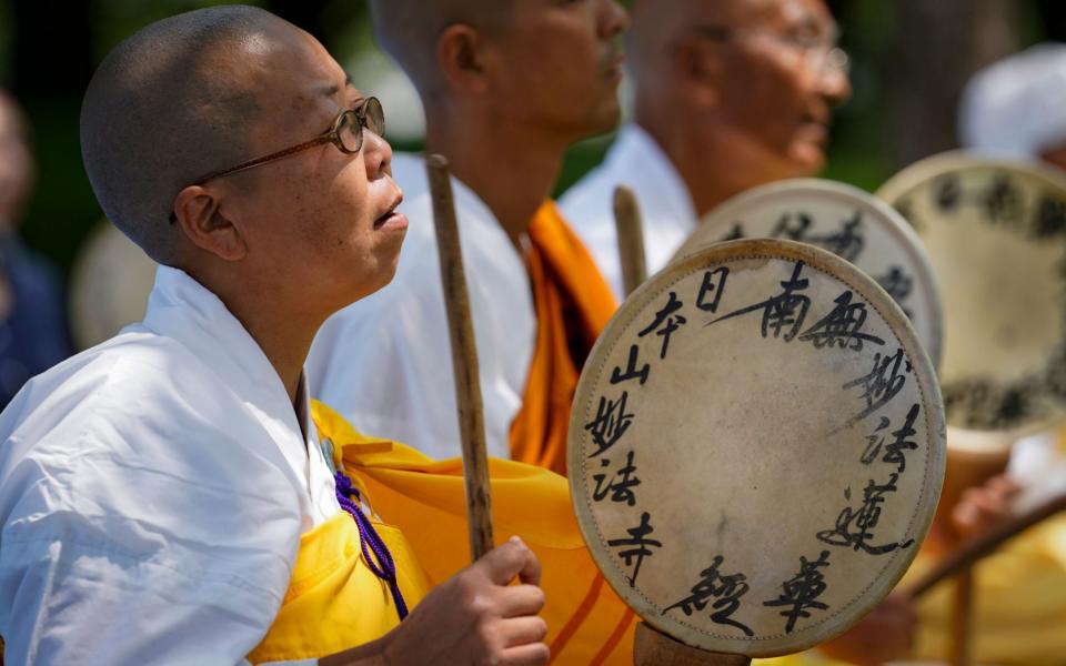 Monks beat hand drums as they pray before the Atomic Bomb Dome in Hiroshima - DAI KUROKAWA/EPA-EFE/Shutterstock /Shutterstock