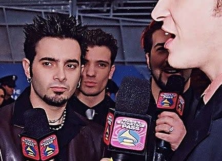 A closeup of the members of NSYNC with mics