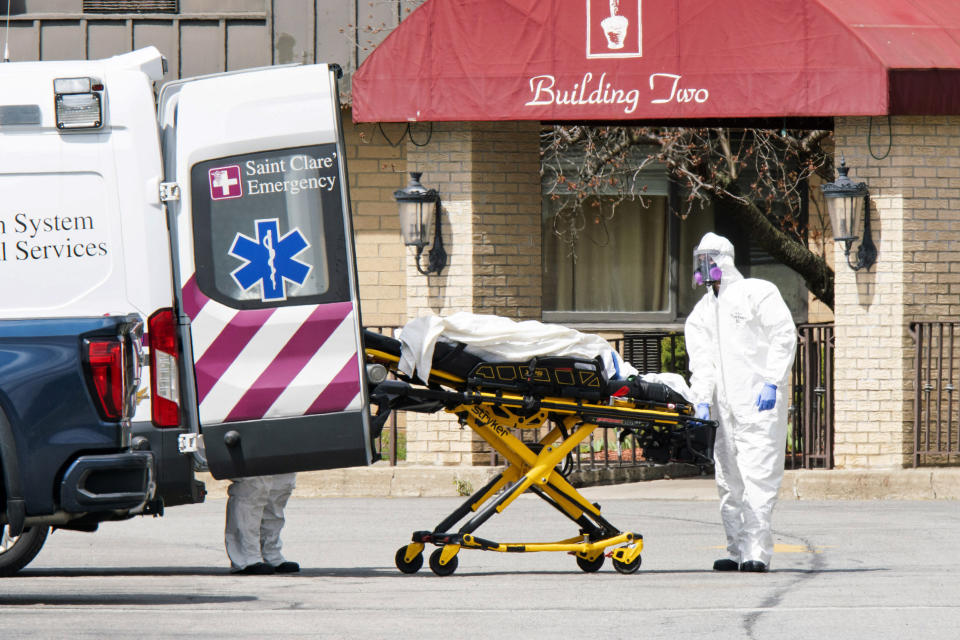 Medical workers load a deceased body into an ambulance outside a New Jersey nursing home. (Photo: Eduardo Munoz Alvarez via Getty Images)