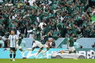 FILE - Saudi Arabia's Salem Al-Dawsari, right, celebrates after scoring his side's second goal during the World Cup group C soccer match between Argentina and Saudi Arabia at the Lusail Stadium in Lusail, Qatar, on Nov. 22, 2022. For a brief moment after Saudi Arabia's Salem Aldawsari fired a soccer ball from just inside the penalty box into the back of the net to seal a win against Argentina, Arabs across the divided Middle East found something to celebrate. (AP Photo/Natacha Pisarenko, File)