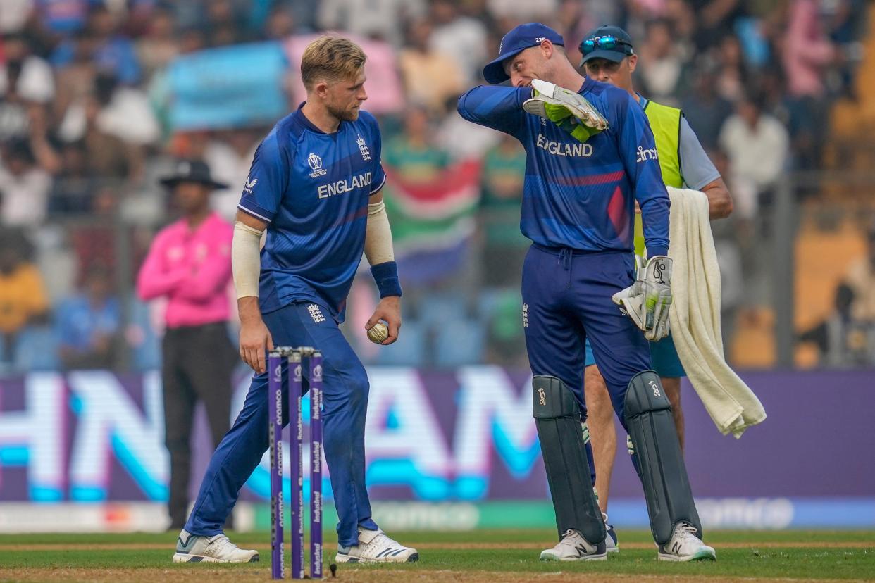 England's captain Jos Butler, right, talks to David Willey (AP)