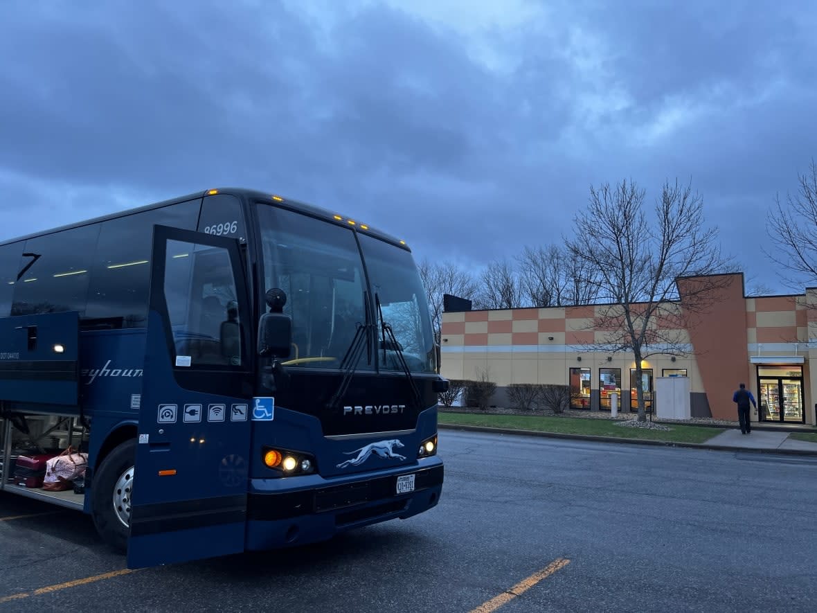 The Greyhound bus heading to New York City picks up passengers at the Mountain Mart bus stop in Plattsburgh in late April.  (Verity Stevenson/CBC - image credit)