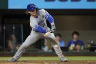 Kansas City Royals' Bobby Witt Jr. connects for a fielders choice in the seventh inning of a baseball game against the Kansas City Royals, Wednesday, May 11, 2022, in Arlington, Texas. Witt Jr., was safe at first and Whit Merrifield scored on the play. (AP Photo/Tony Gutierrez)