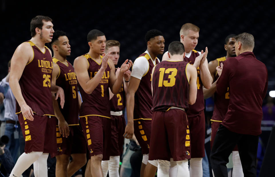 Loyola-Chicago head coach Porter Moser, right, talks to his team during a practice session for the Final Four NCAA college basketball tournament, Friday, March 30, 2018, in San Antonio. (AP Photo/David J. Phillip)