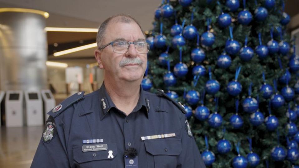 Road Policing Assistant Commissioner Glenn Weir stands before the Christmas tree with a bauble for each life lost on the state's roads for 2023. Picture: Supplied