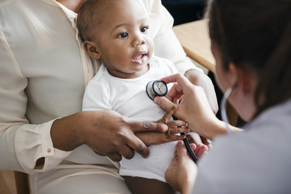 Pediatric doctor checking baby's heart