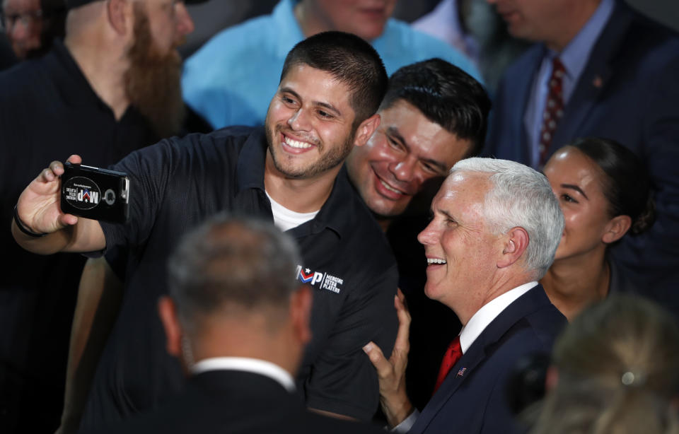 Vice President Mike Pence, right, poses for photos with guests after during a visit to Nellis Air Force Base in Las Vegas, Friday, Sept. 7, 2018. (Steve Marcus/Las Vegas Sun via AP)