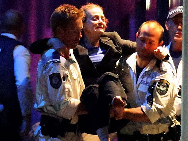 Marcia Mikhael is carried out by police after the 17-hour siege. Photo: Getty Images