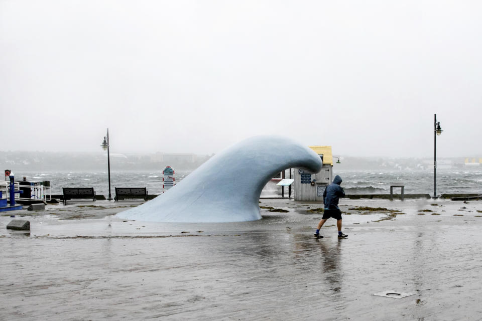 A man struggles to walk through strong winds in Halifax, Nova Scotia, on Saturday, Sept. 16, 2023. Severe conditions were predicted across parts of Massachusetts and Maine, and hurricane conditions could hit the Canadian provinces of New Brunswick and Nova Scotia, where the storm, Lee, downgraded early Saturday from hurricane to post-tropical cyclone, was expected to make landfall later in the day. (Kelly Clark/The Canadian Press via AP)