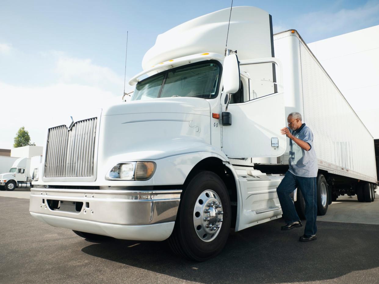 truck driver stepping into a truck