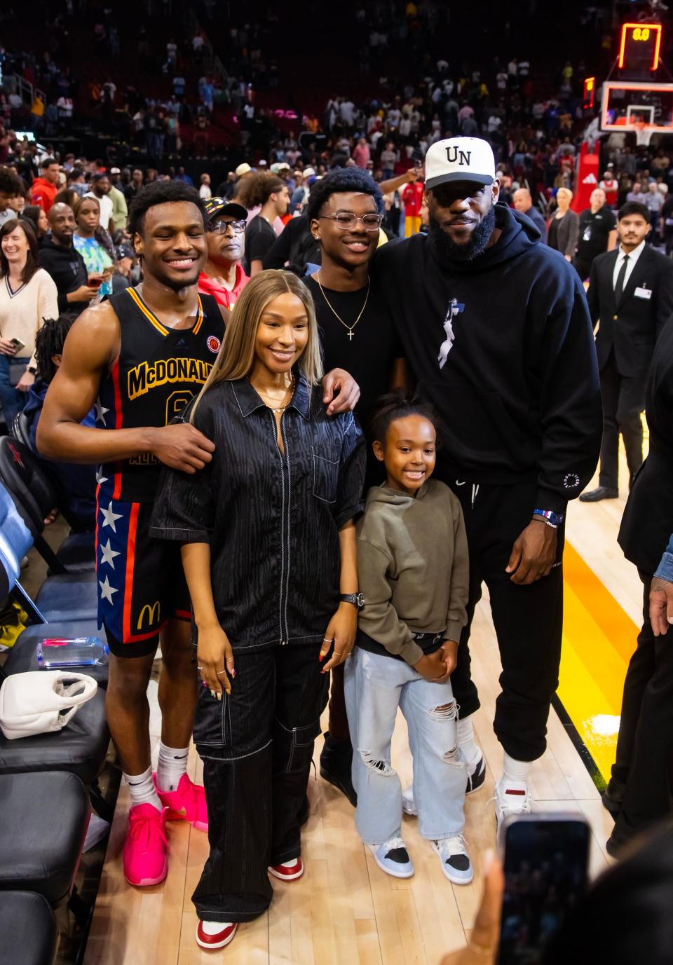 Bronny James (6) takes a photo with his family after the McDonald's All American game.