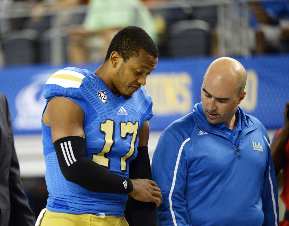 Sep 13, 2014; Arlington, TX, USA; UCLA Bruins quarterback Brett Hundley (17) is taken off the field after an injury against the Texas Longhorns during the second quarter at AT&T Stadium. (Richard Mackson-USA TODAY Sports)